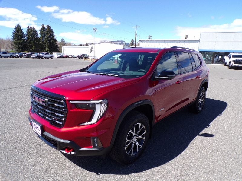 2026 GMC Acadia AT4 in Volcanic Red Tintcoat — front three-quarter view